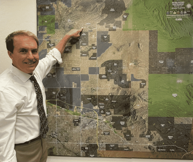 August 2022 Greeting From Darrell Darrell pointing to a map on the wall