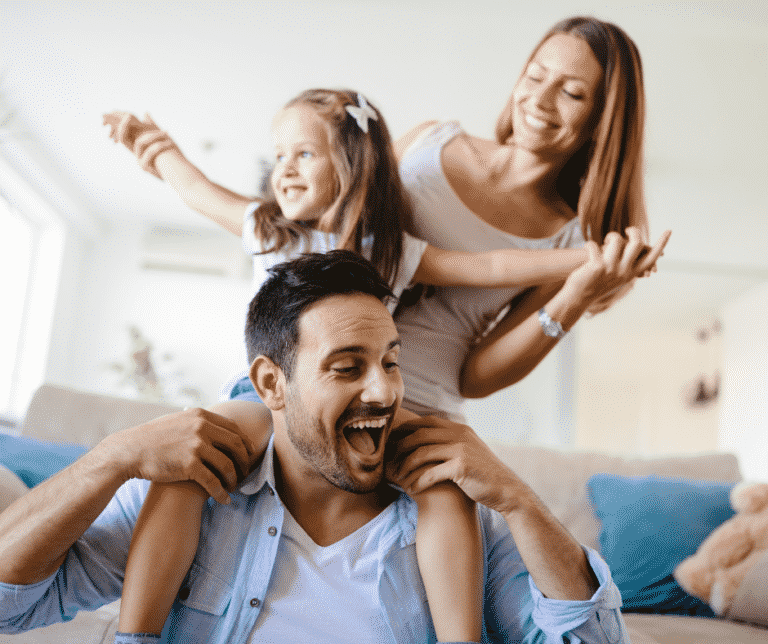 Parents playing with daughter in living room